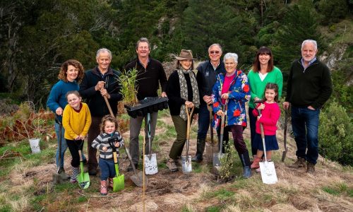 Image: Mucking in to mark the milestone, a group of Hawke's Bay Foundation cornerstone donor families, from left to right: Annabel Murphy and children Tillie (8) and Marco (3), James Williams, Tim and Jules Nowell-Usticke, Craig Hickson and wife Penny with daughter Anna Ducker and granddaughter Greer and pictured far right, Lyn Williams. (Image courtesy of Richard Brimer)